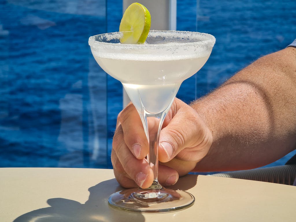 Refreshing margarita cocktail with lime on a cruise ship deck.