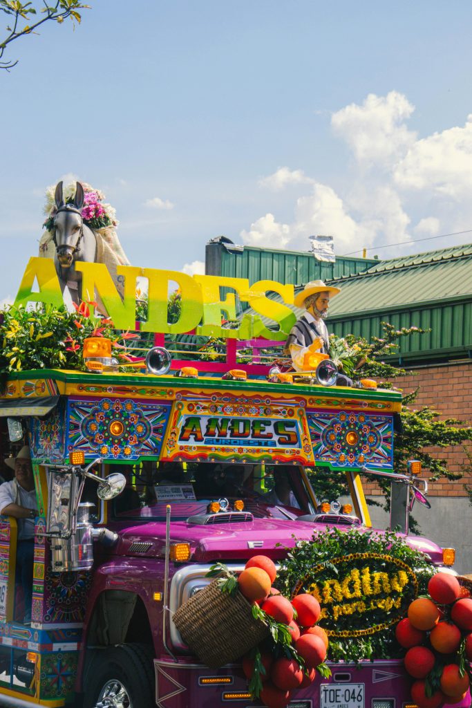 Vibrant Colombian chiva bus adorned for Feria de Flores in Medellín, Antioquia.